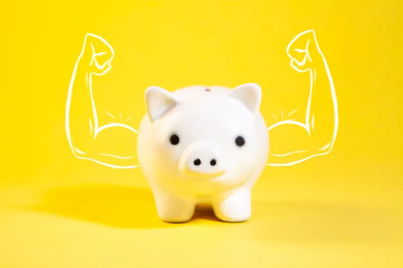 Piggy bank with muscle on a yellow background. The concept of a healthy lifestyle.
